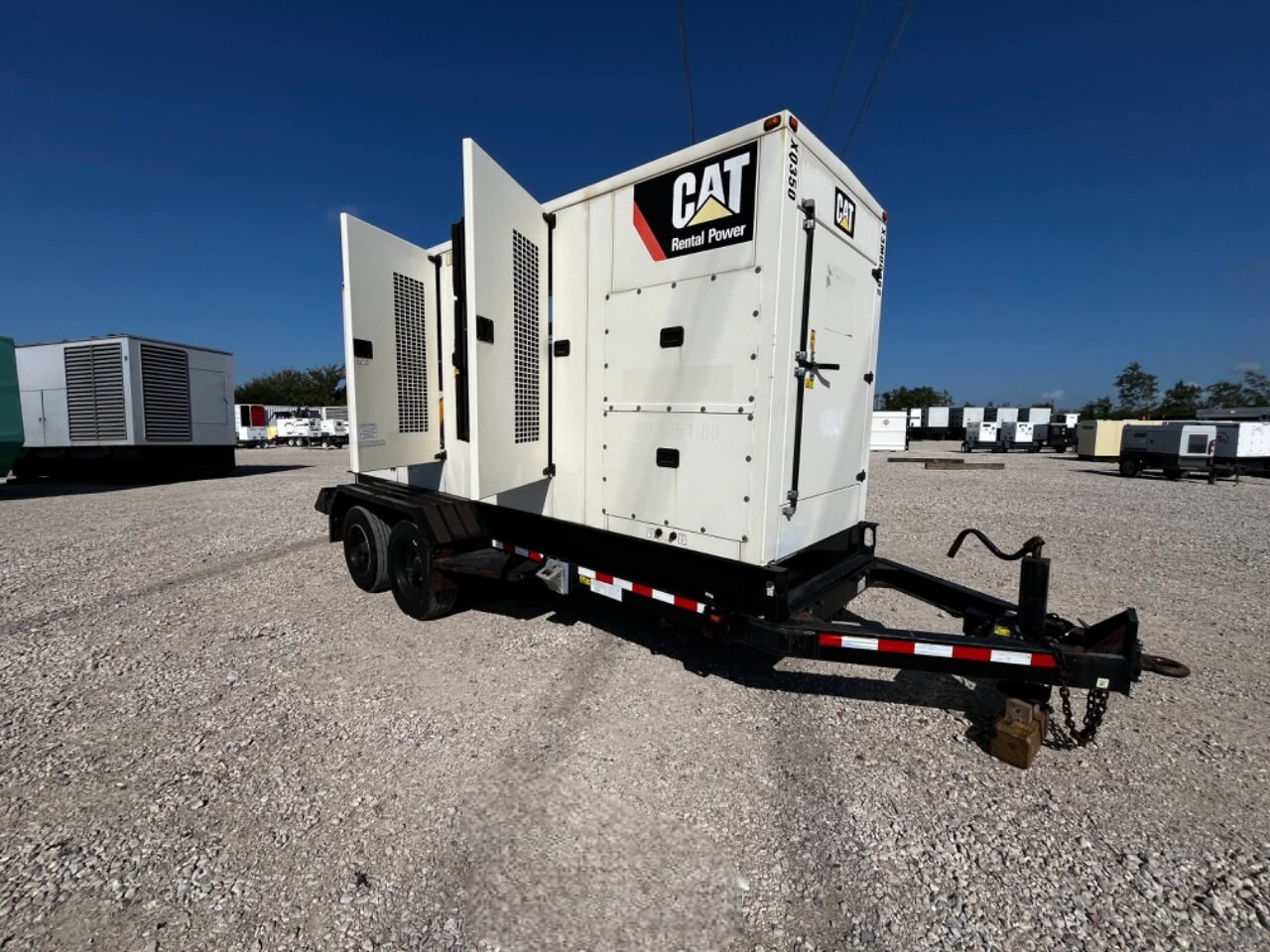 Caterpillar XQ350 trailer-mounted rental generator with doors open